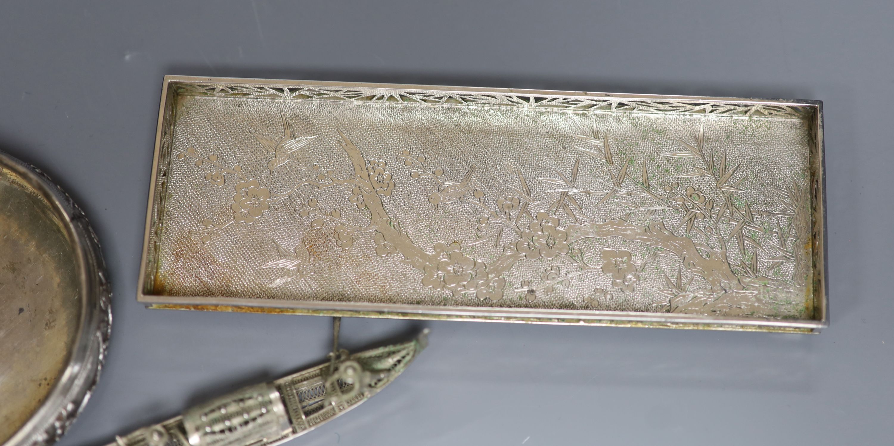 An early 20th century Chinese Export white metal rectangular tray, maker LH, 18.8cm, together with a similar bonbon basket and a small filigree junk